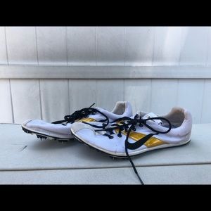 Black white and gold nike running spikes